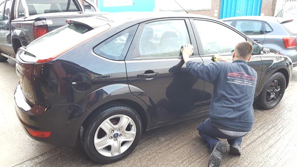 Dark blue Ford after accident repair and respray
