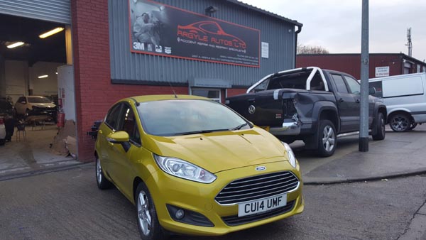 Ford Fiesta finished in bright yellow outside the Argyle Autos workshop